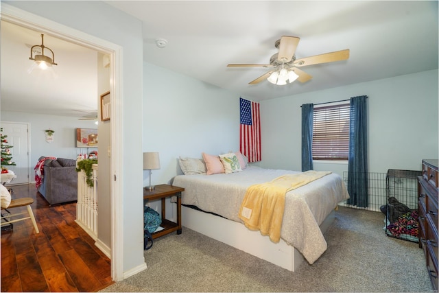 bedroom with dark hardwood / wood-style floors and ceiling fan