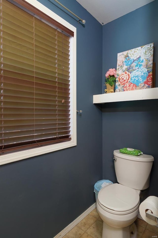 bathroom featuring tile patterned flooring and toilet