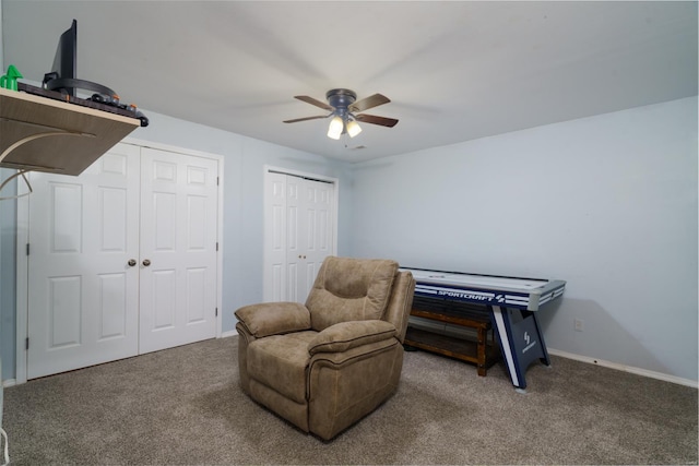 living area featuring ceiling fan and carpet floors