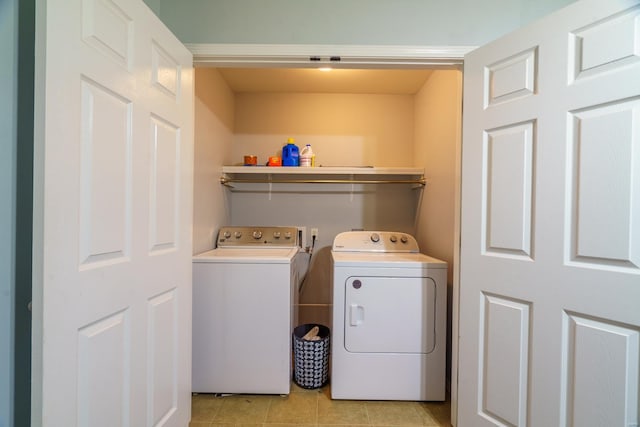 laundry area with separate washer and dryer and light tile patterned flooring