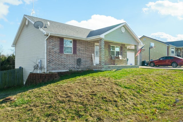 single story home with a garage and a front lawn