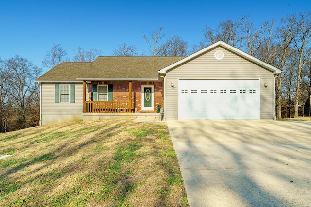 ranch-style home with covered porch, a garage, and a front lawn