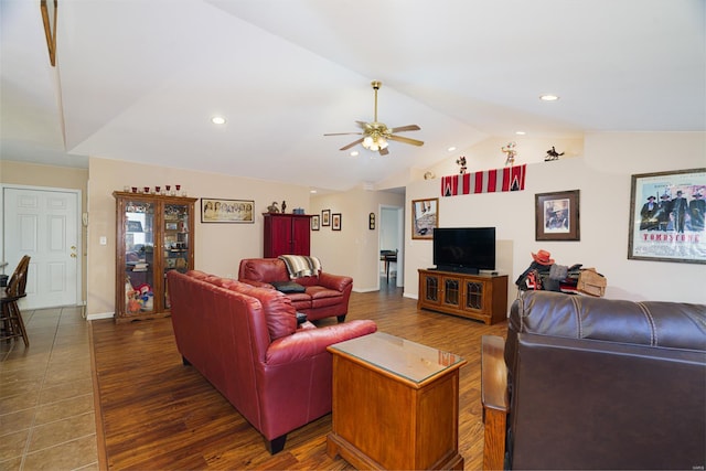 living room with ceiling fan, dark hardwood / wood-style flooring, and lofted ceiling