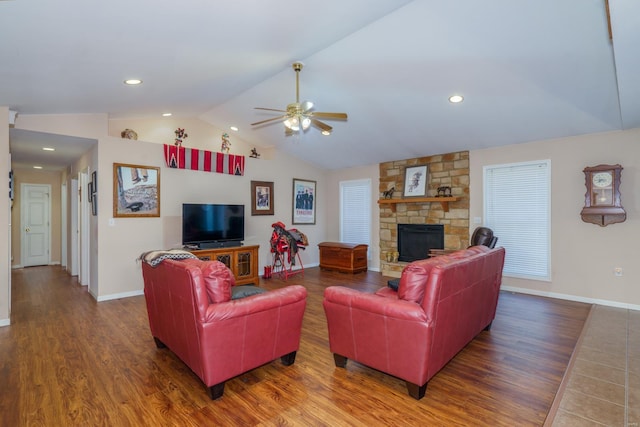 living room with a fireplace, ceiling fan, dark hardwood / wood-style flooring, and lofted ceiling