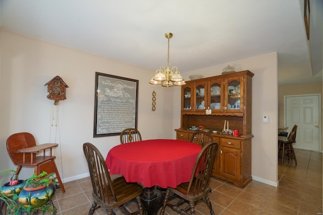 tiled dining area with a notable chandelier