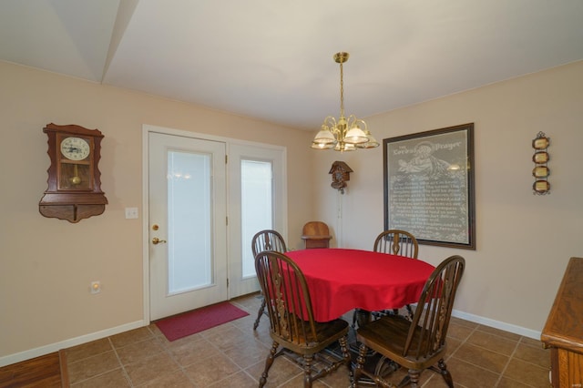 dining room featuring tile patterned flooring and a notable chandelier