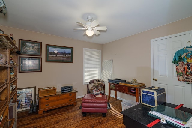 living area featuring dark hardwood / wood-style floors and ceiling fan