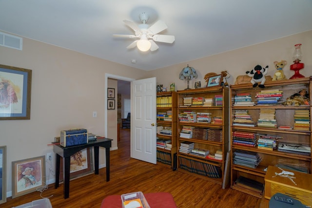 misc room featuring ceiling fan and dark wood-type flooring