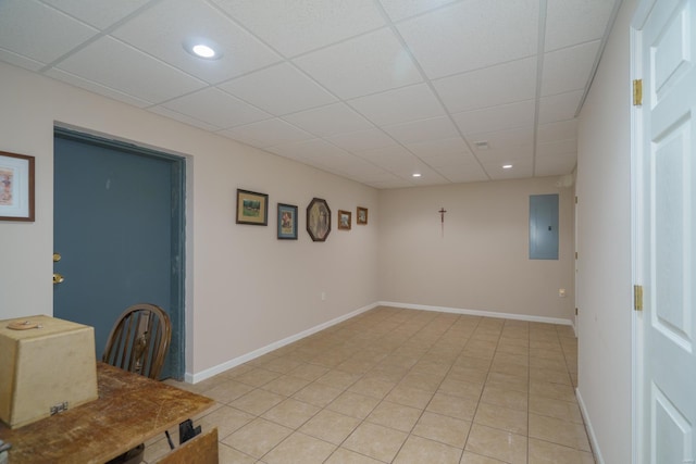 interior space featuring a paneled ceiling and electric panel