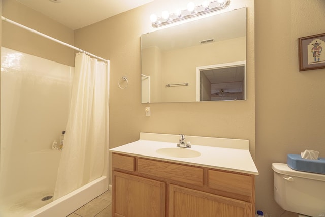 bathroom featuring tile patterned floors, vanity, toilet, and a shower with shower curtain