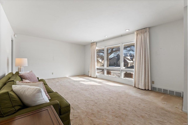 living room featuring light carpet and visible vents