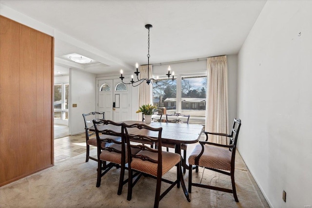 dining area with a notable chandelier and light colored carpet