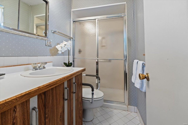 bathroom with toilet, a stall shower, vanity, tile patterned flooring, and wallpapered walls