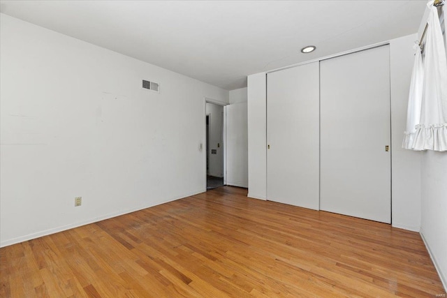 unfurnished bedroom featuring light wood-type flooring and visible vents