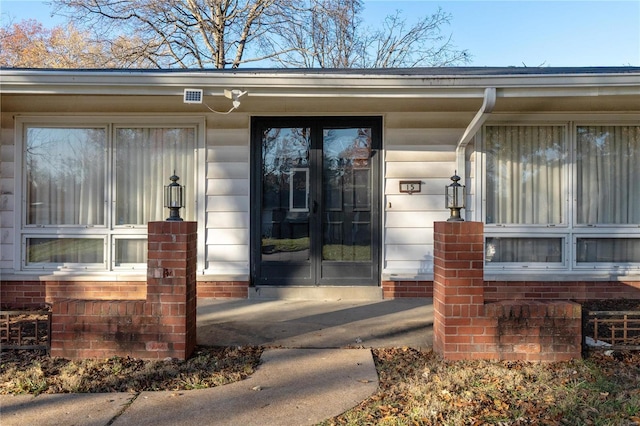 view of exterior entry featuring french doors