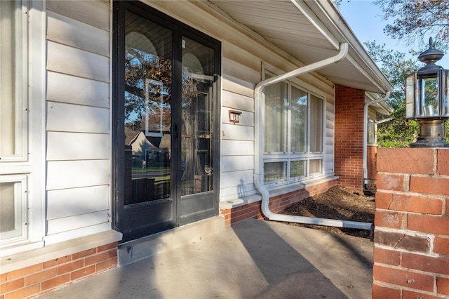 property entrance with brick siding