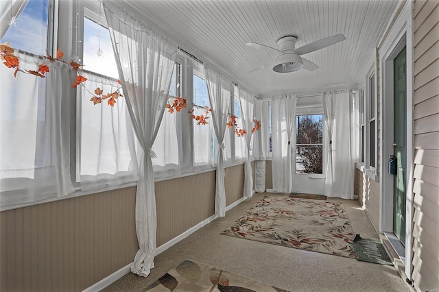 unfurnished sunroom with ceiling fan