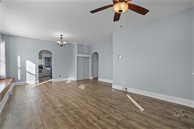 unfurnished living room with dark hardwood / wood-style floors and ceiling fan with notable chandelier