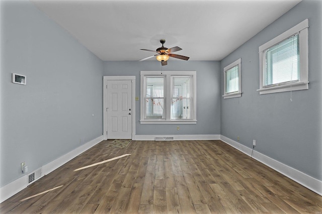 spare room with ceiling fan and dark hardwood / wood-style flooring