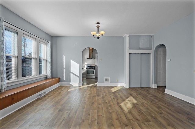 interior space featuring dark hardwood / wood-style floors and an inviting chandelier