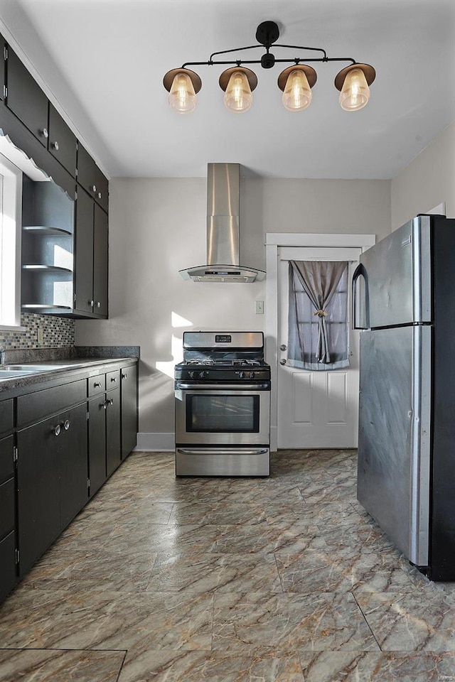 kitchen with sink, backsplash, appliances with stainless steel finishes, and wall chimney range hood