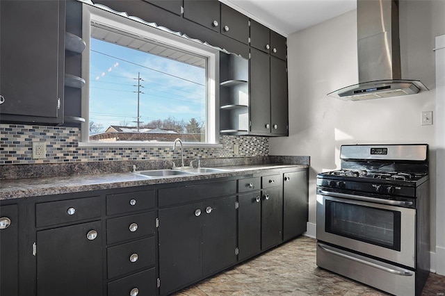 kitchen featuring decorative backsplash, sink, wall chimney exhaust hood, and gas stove