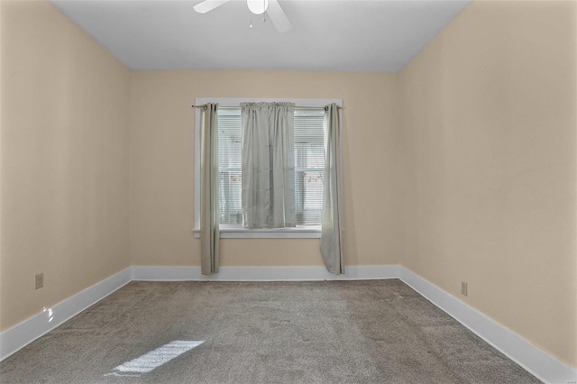 carpeted spare room with ceiling fan