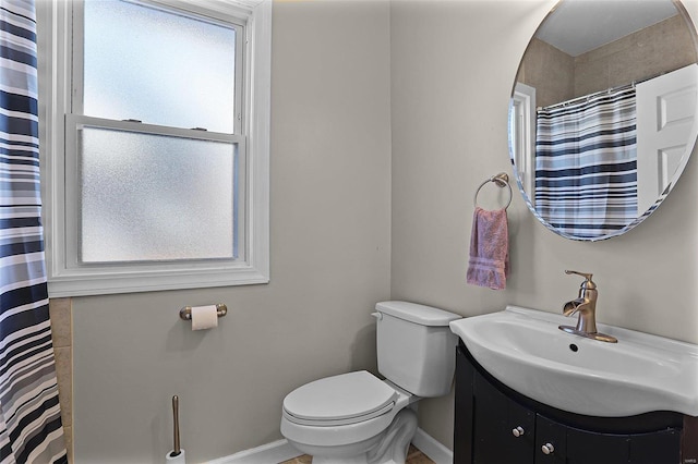 bathroom featuring toilet and vanity