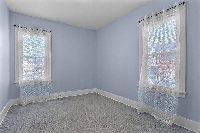 spare room featuring carpet floors and a healthy amount of sunlight