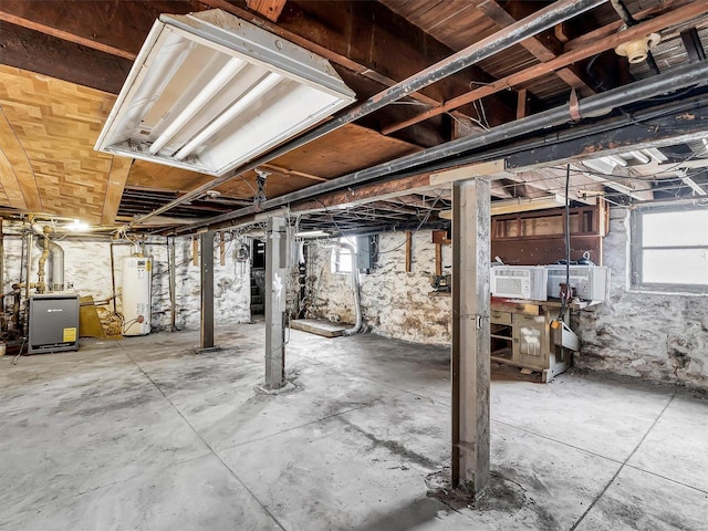 basement with plenty of natural light and gas water heater