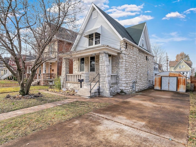 view of front of house with covered porch and a storage unit