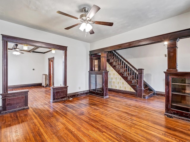 unfurnished living room featuring ceiling fan and hardwood / wood-style floors