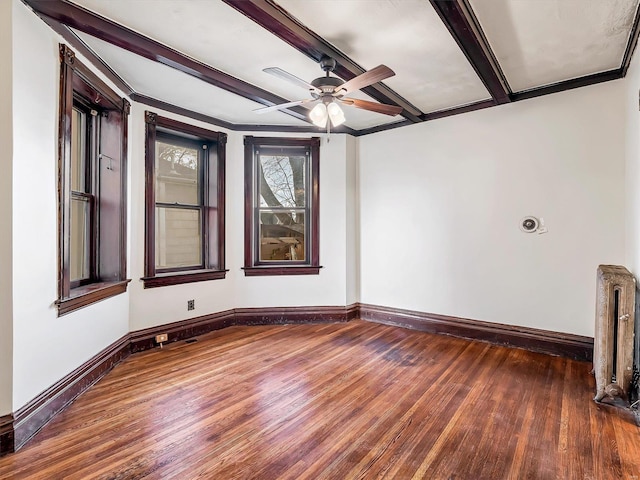 unfurnished room featuring ceiling fan, beamed ceiling, ornamental molding, and hardwood / wood-style flooring