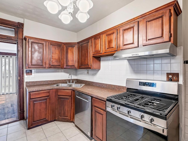 kitchen featuring backsplash, stainless steel appliances, sink, light tile patterned floors, and a notable chandelier