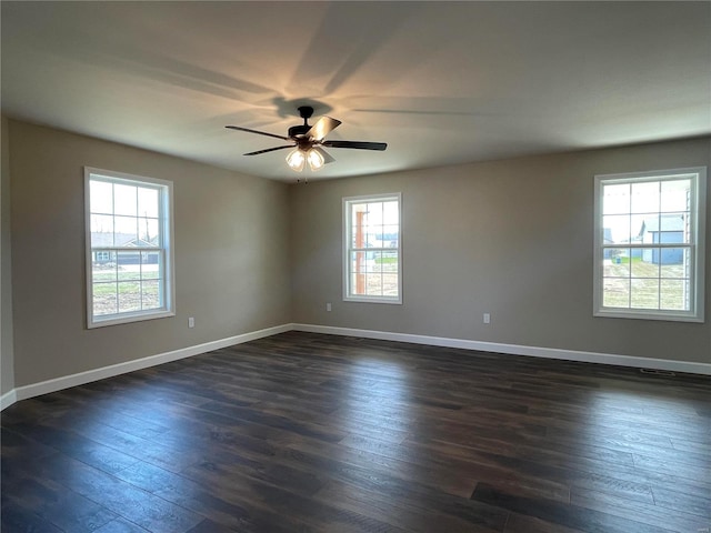 unfurnished room featuring ceiling fan and dark wood-type flooring