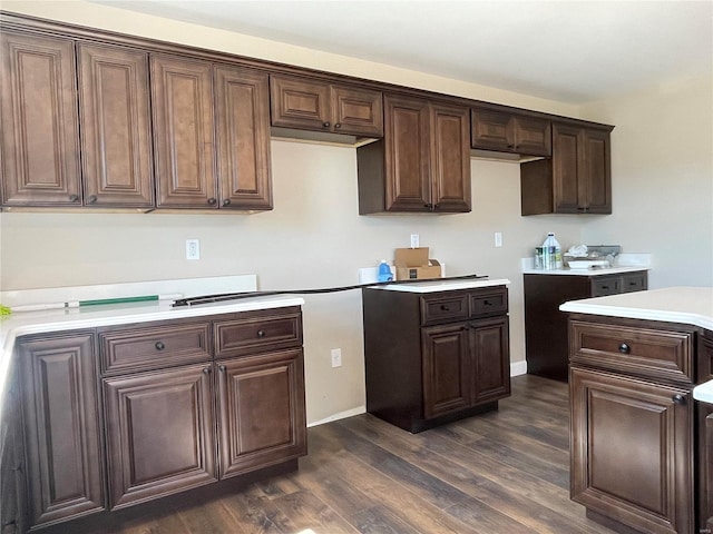 kitchen with dark brown cabinets and dark wood-type flooring