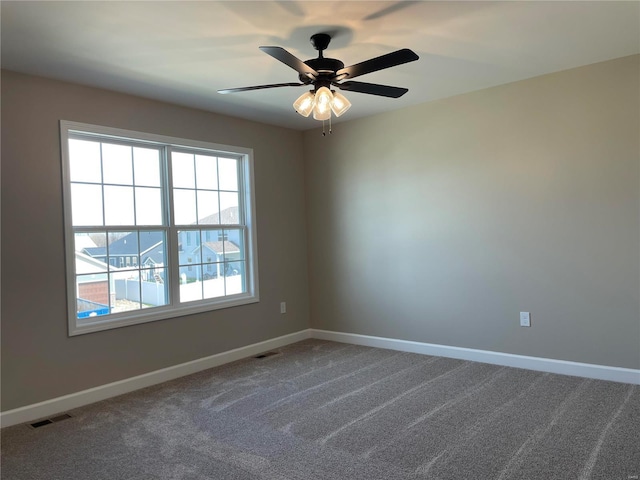 empty room featuring carpet flooring and ceiling fan