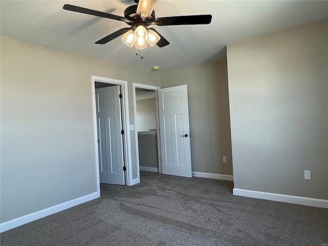 unfurnished bedroom with ceiling fan, dark carpet, and a closet