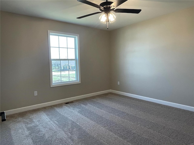 spare room with ceiling fan and carpet