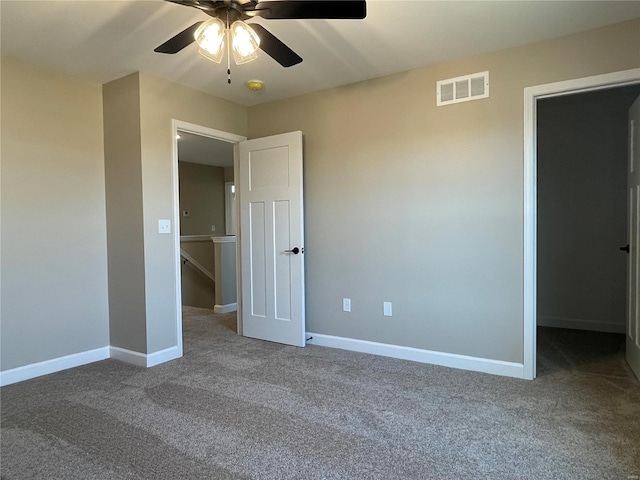 carpeted empty room featuring ceiling fan