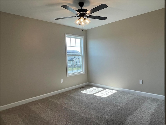 spare room featuring carpet floors and ceiling fan