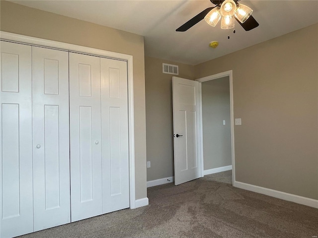 unfurnished bedroom featuring ceiling fan, a closet, and carpet floors