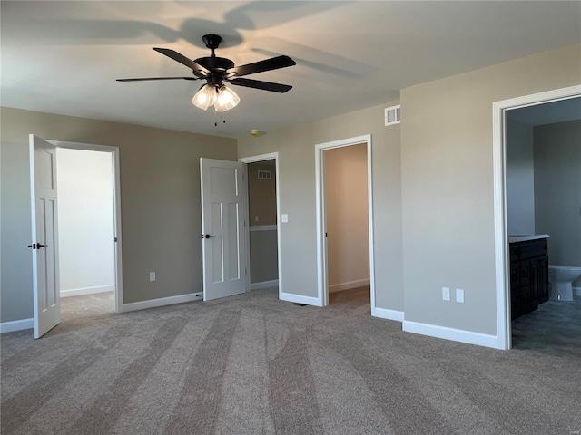 unfurnished bedroom featuring carpet floors, ensuite bathroom, and ceiling fan