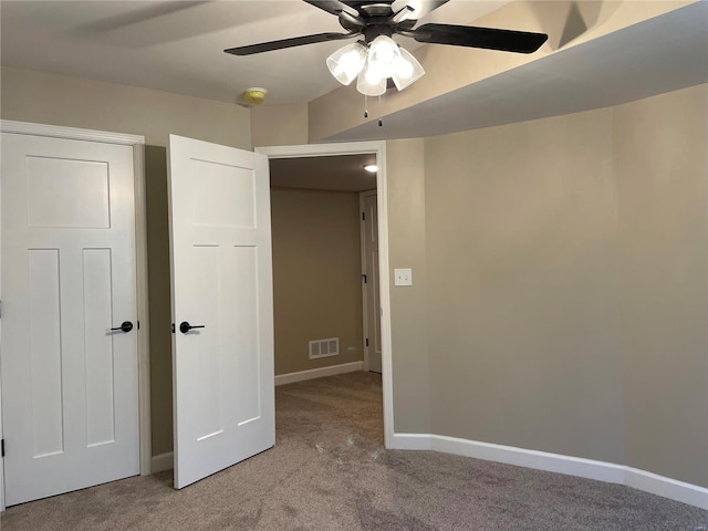 unfurnished bedroom featuring ceiling fan and light carpet