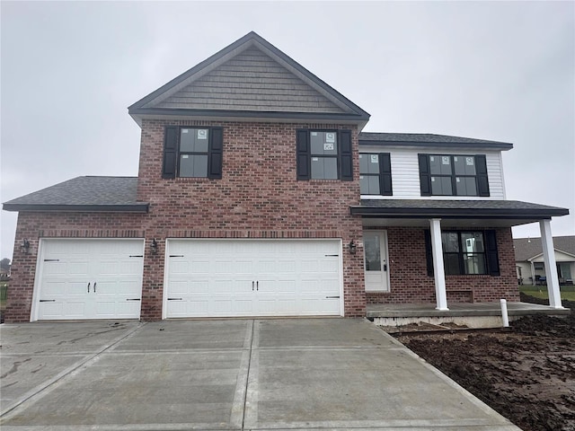 view of front of property with a porch and a garage