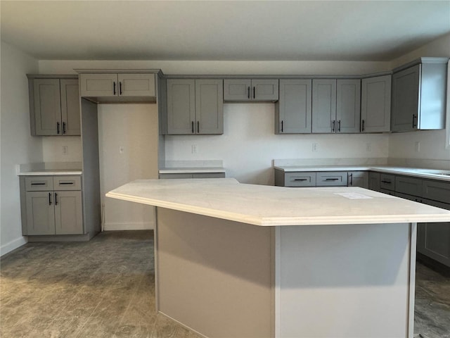 kitchen with hardwood / wood-style flooring, a center island, and gray cabinetry