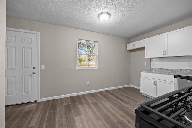 kitchen with white cabinets, dark hardwood / wood-style floors, and dishwasher