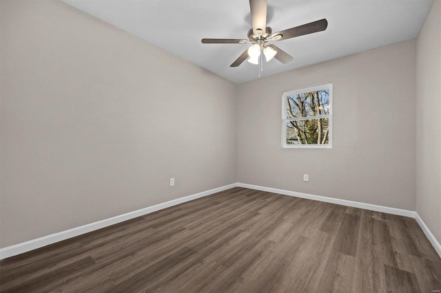 spare room with dark hardwood / wood-style floors and ceiling fan