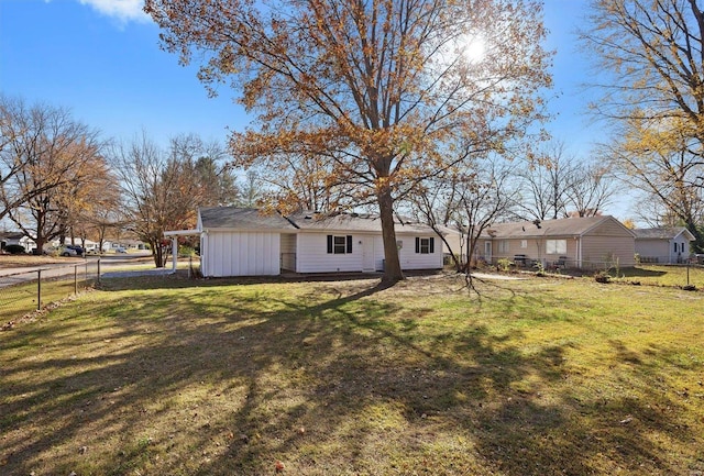 rear view of property with a lawn