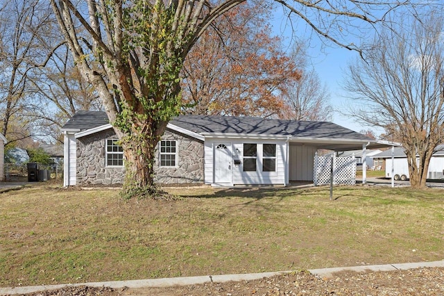 rear view of property with a carport and a lawn